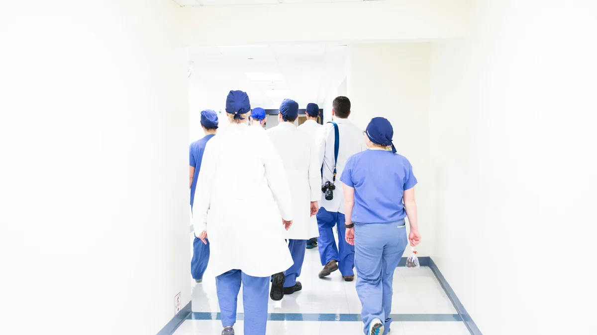 Clinical team walking together through a hospital corridor